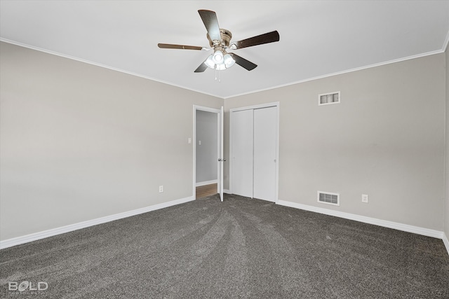 unfurnished bedroom with a closet, ceiling fan, ornamental molding, and dark carpet