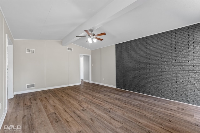 unfurnished room with lofted ceiling with beams, wood-type flooring, brick wall, and ceiling fan