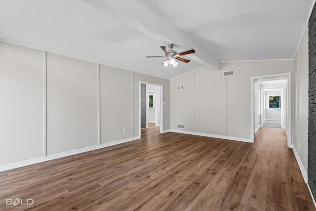 unfurnished room with ceiling fan, lofted ceiling with beams, and wood-type flooring