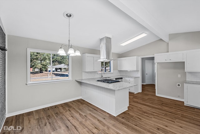 kitchen with white cabinetry, tasteful backsplash, wood-type flooring, and kitchen peninsula