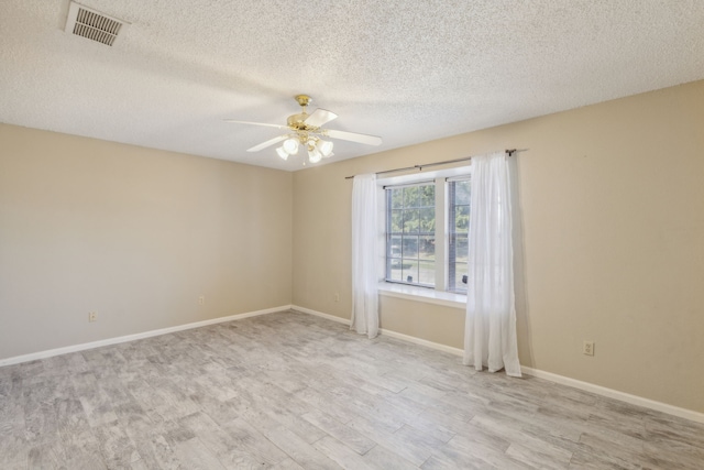 spare room featuring ceiling fan, a textured ceiling, and light hardwood / wood-style flooring