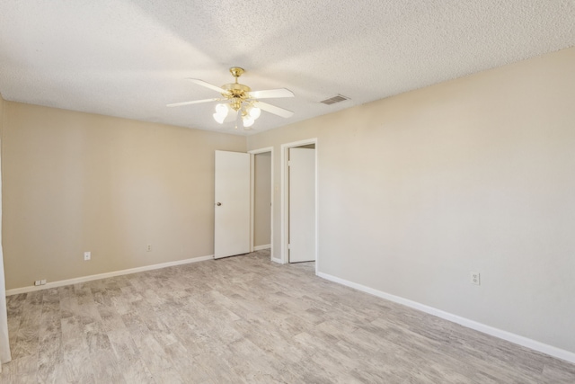 unfurnished room with light hardwood / wood-style floors, a textured ceiling, and ceiling fan