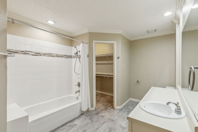 bathroom with vanity, crown molding, and a textured ceiling