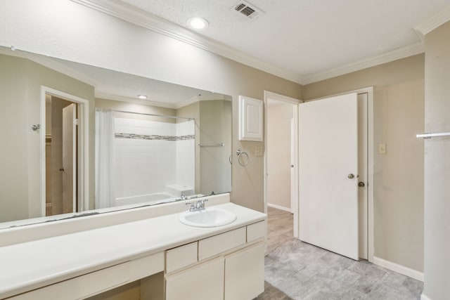 bathroom with vanity, a textured ceiling, shower / bath combo with shower curtain, and ornamental molding