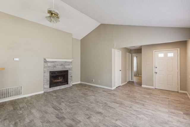 unfurnished living room with light hardwood / wood-style floors, vaulted ceiling, and ceiling fan