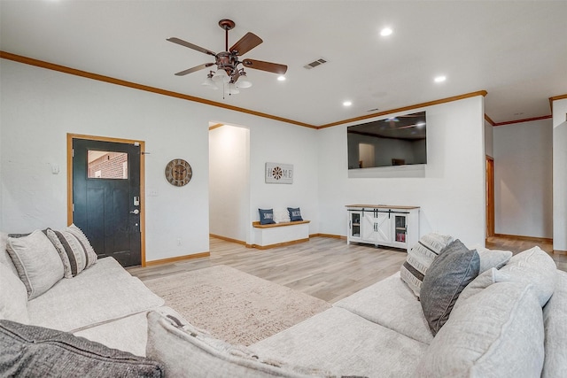 living room with light hardwood / wood-style flooring, ornamental molding, and sink