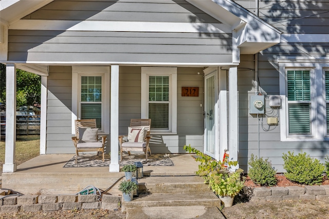 view of exterior entry featuring covered porch