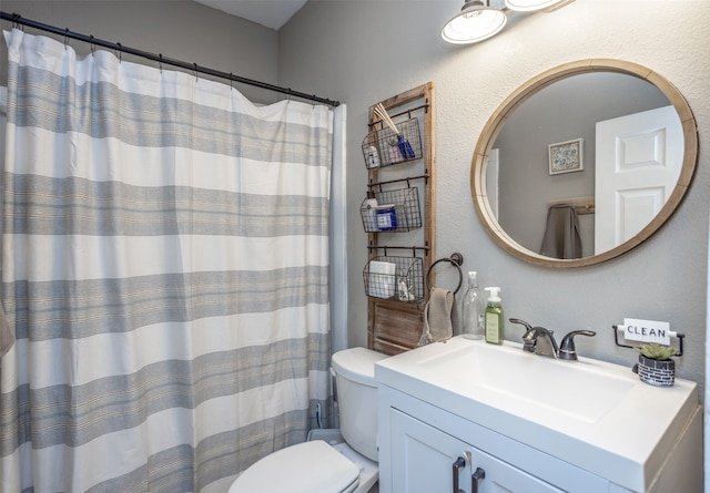 bathroom with toilet, a shower with curtain, and vanity