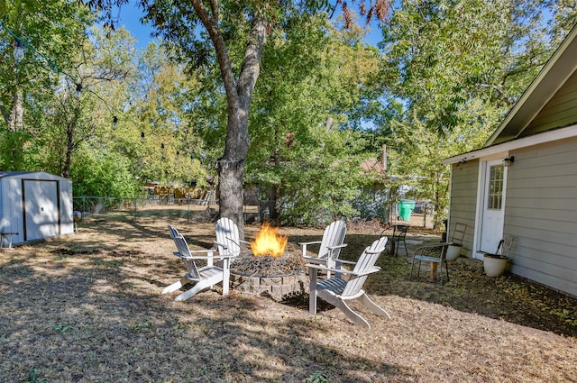 view of yard featuring a shed and a fire pit