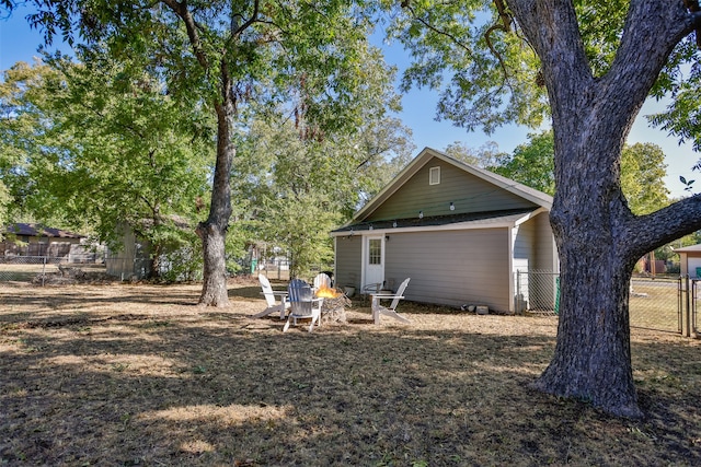 view of property exterior featuring an outdoor fire pit