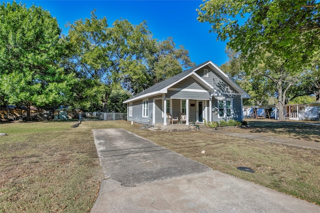 bungalow with a porch and a front yard