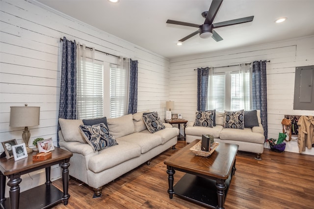 living room featuring ceiling fan, electric panel, wooden walls, and dark hardwood / wood-style flooring