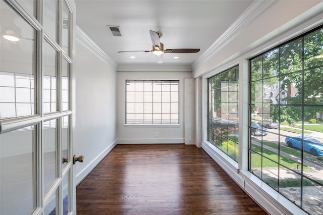 unfurnished sunroom with ceiling fan