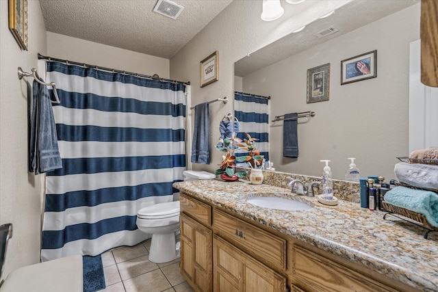 bathroom featuring tile patterned floors, toilet, a textured ceiling, vanity, and a shower with shower curtain