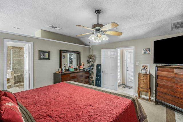 carpeted bedroom with lofted ceiling, a textured ceiling, connected bathroom, and ceiling fan