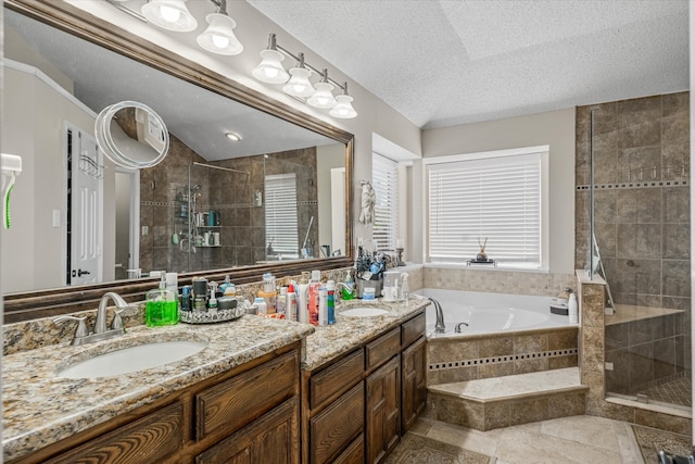 bathroom with separate shower and tub, a textured ceiling, and vanity