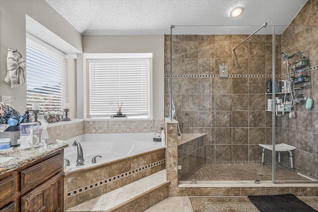 bathroom with a textured ceiling and separate shower and tub