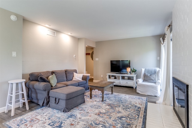 living room featuring a fireplace and hardwood / wood-style flooring