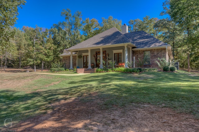 view of front of house with a front yard and covered porch