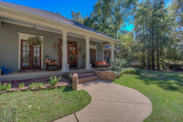 property entrance with a yard, covered porch, and french doors