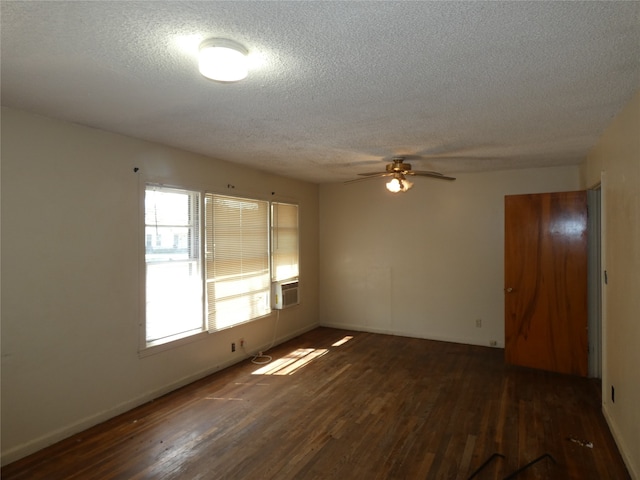 spare room with ceiling fan, a textured ceiling, and dark hardwood / wood-style flooring