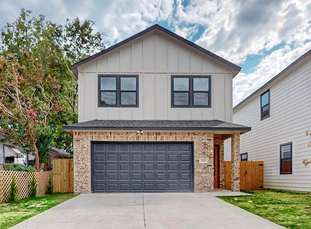 view of front of house with a front yard and a garage