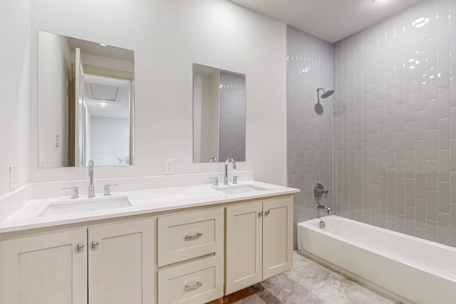 bathroom with vanity and tiled shower / bath combo