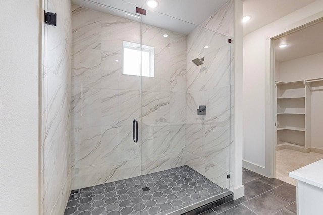 bathroom with a shower with door, tile patterned flooring, and vanity