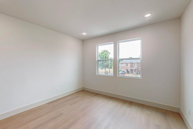 empty room with light hardwood / wood-style flooring