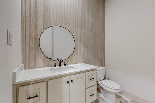 bathroom featuring toilet and vanity