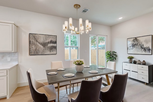 dining area featuring a chandelier and light hardwood / wood-style flooring