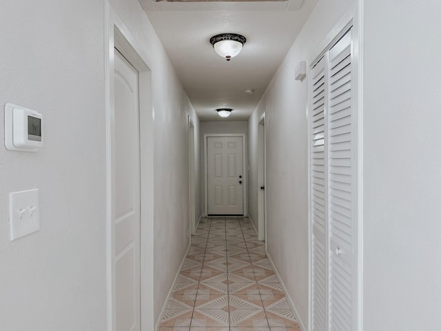 corridor with light tile patterned floors