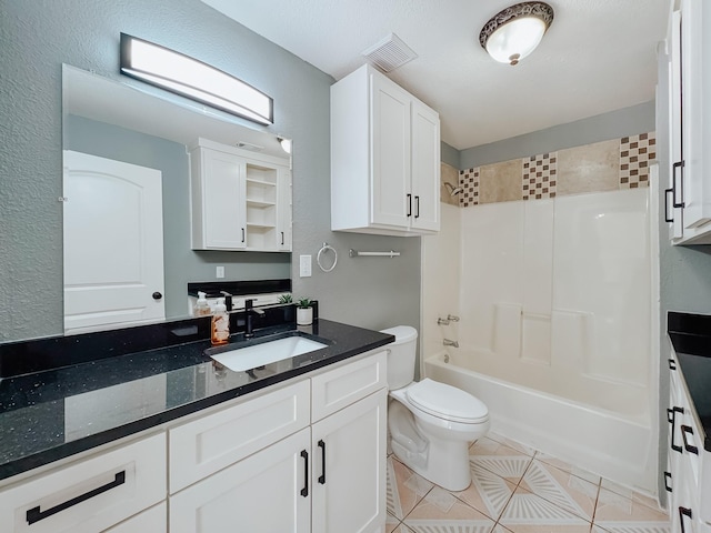 full bathroom featuring toilet, vanity, tile patterned floors, and tub / shower combination