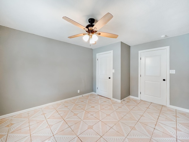 unfurnished room featuring ceiling fan and light tile patterned floors