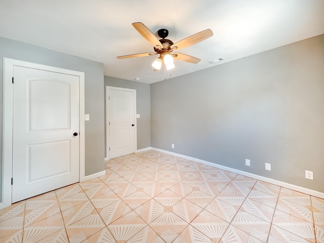 tiled empty room with ceiling fan