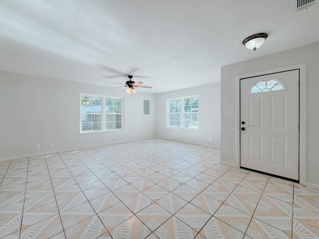 812 W 11th Ave, Corsicana, TX 75110 - foyer entrance featuring a ceiling fan, light tile patterned floors, and electric panel