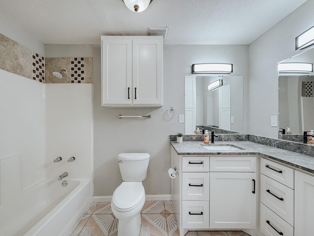 full bathroom featuring tile patterned floors, vanity, a textured ceiling, shower / bathing tub combination, and toilet