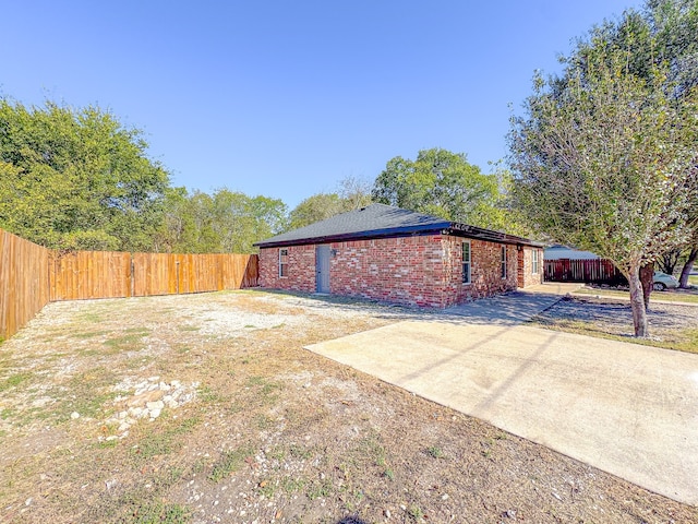 view of side of home with a patio