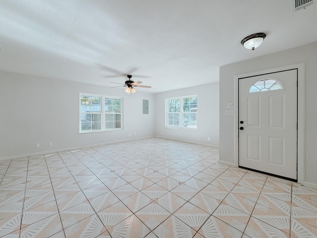 foyer entrance with electric panel, ceiling fan, and light tile patterned floors