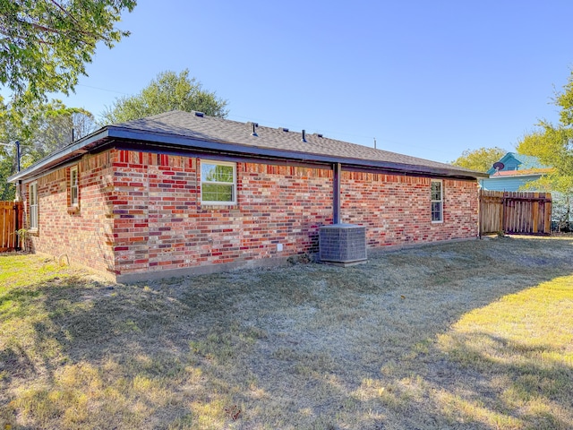 view of home's exterior with a yard and cooling unit