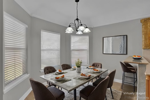 dining space featuring crown molding, a notable chandelier, and plenty of natural light