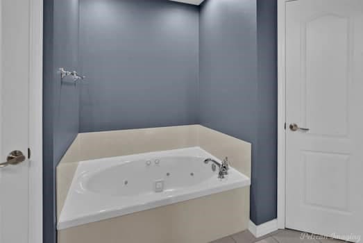 bathroom featuring a bathtub and tile patterned floors