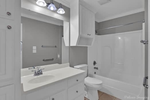 full bathroom with vanity, toilet, tile patterned floors, and bathing tub / shower combination