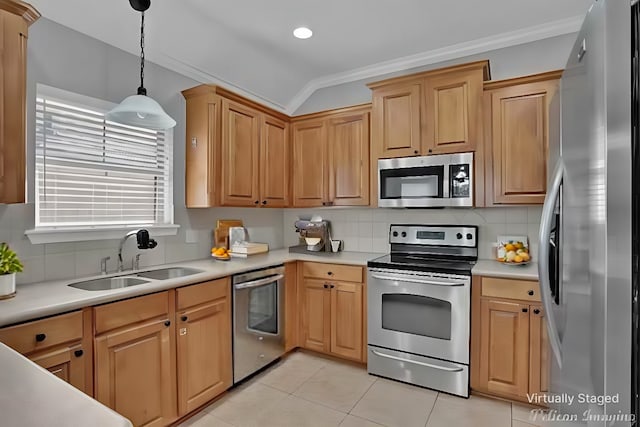 kitchen with sink, stainless steel appliances, decorative light fixtures, ornamental molding, and light tile patterned floors