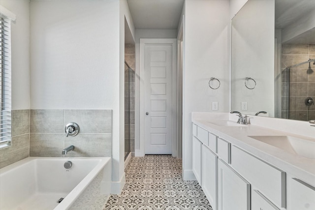 full bath with a stall shower, a garden tub, and a sink