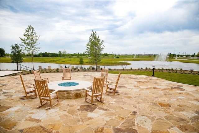 view of patio featuring a water view and a fire pit