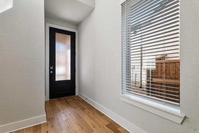 entryway featuring light wood-style flooring and baseboards