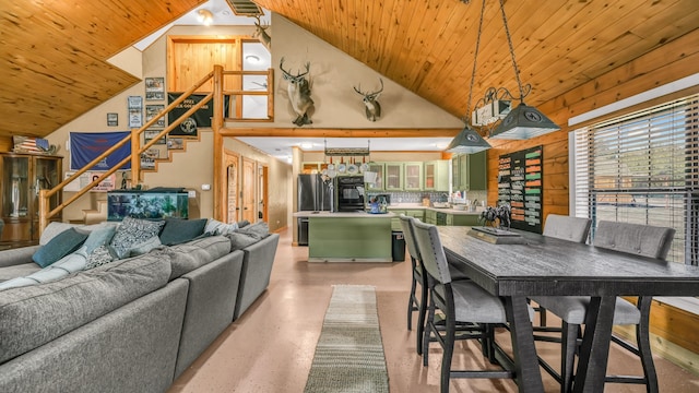 dining room with wood ceiling, wood walls, and high vaulted ceiling