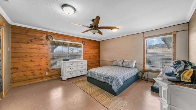 bedroom featuring a textured ceiling, ornamental molding, wooden walls, and ceiling fan