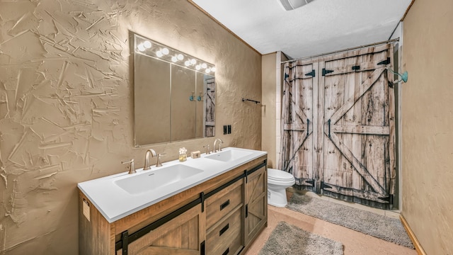 bathroom featuring vanity, a shower with curtain, a textured ceiling, and toilet